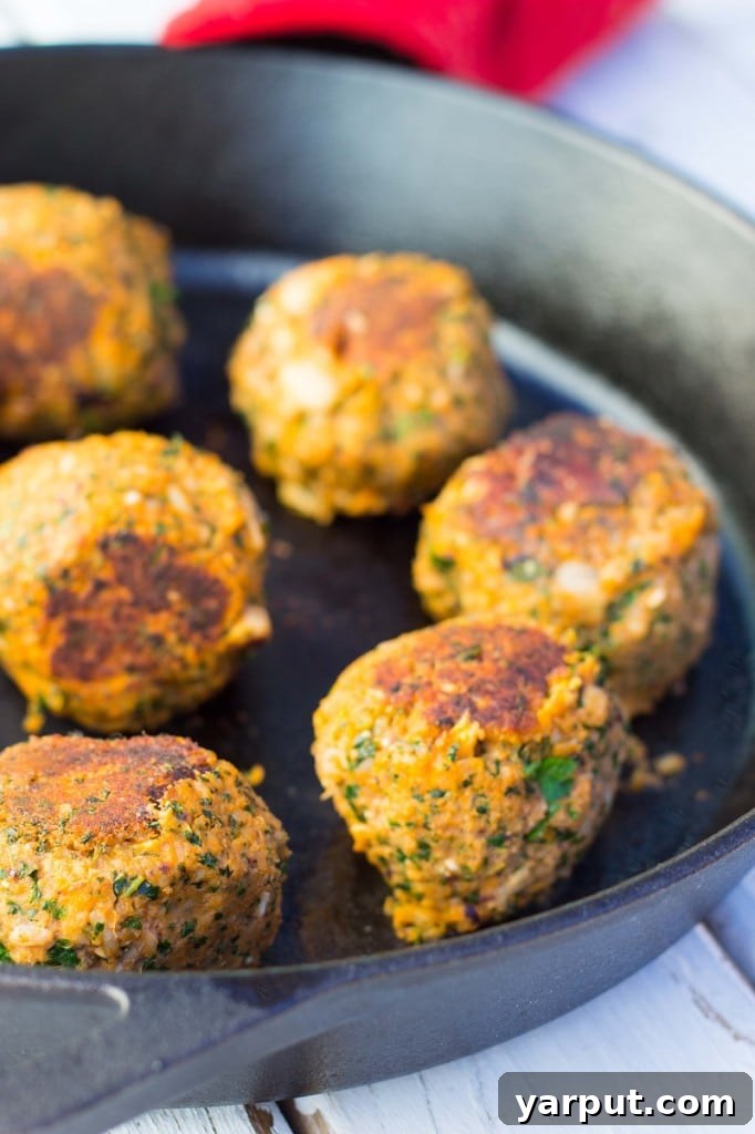Plant-Powered Feta and Kale Sliders with White Beans 4 Vegetarian Meatball Sliders ready to be served, showing their golden-brown exterior