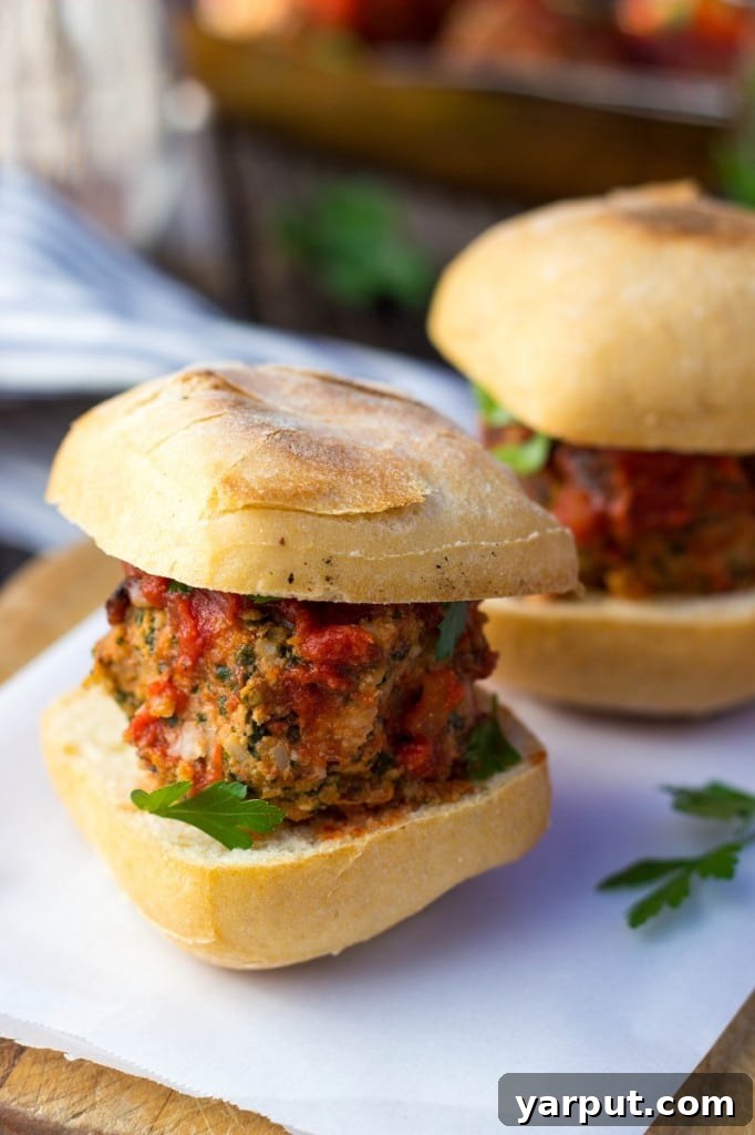 Plant-Powered Feta and Kale Sliders with White Beans 8 A delicious vegetarian meatball slider on a bun, showing off its rich filling