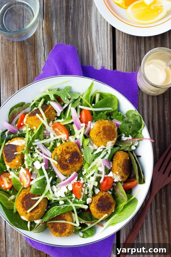 Golden Carrot Falafel Salad Drizzled with Zesty Citrus Tahini 9 An close-up detail of the roasted carrot falafel itself, showing its inviting golden-brown exterior and hinting at the tender interior.