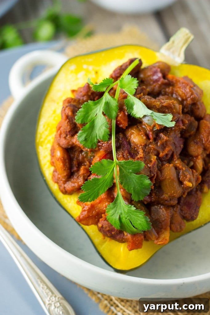 Spicy Chili Roasted Acorn Squash 6 Two halves of Chili Stuffed Acorn Squash on a wooden board