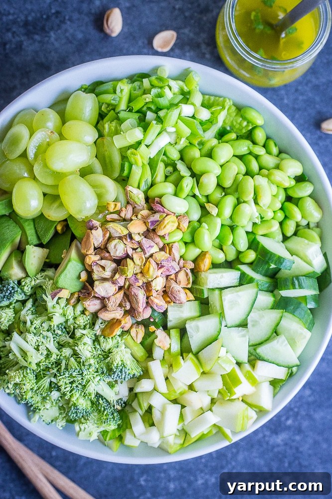 Ultimate Green Chopped Medley 3 A close-up of The Greenest Chopped Salad showing the texture and colors of the ingredients, including finely chopped broccoli, vibrant green edamame, and glistening green grapes.
