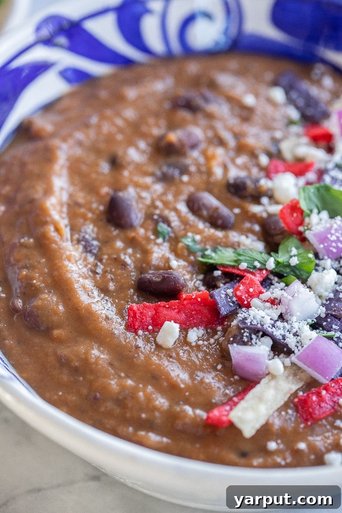 close up of this black bean and sweet potato soup in a bowl