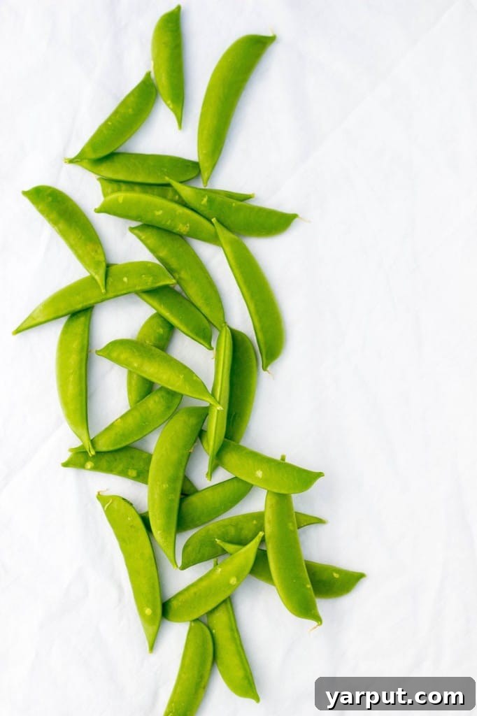 Vibrant Spring Pasta Medley 5 Sweet and crisp sugar snap peas, freshly halved and prepared to be added to a refreshing spring pasta salad.