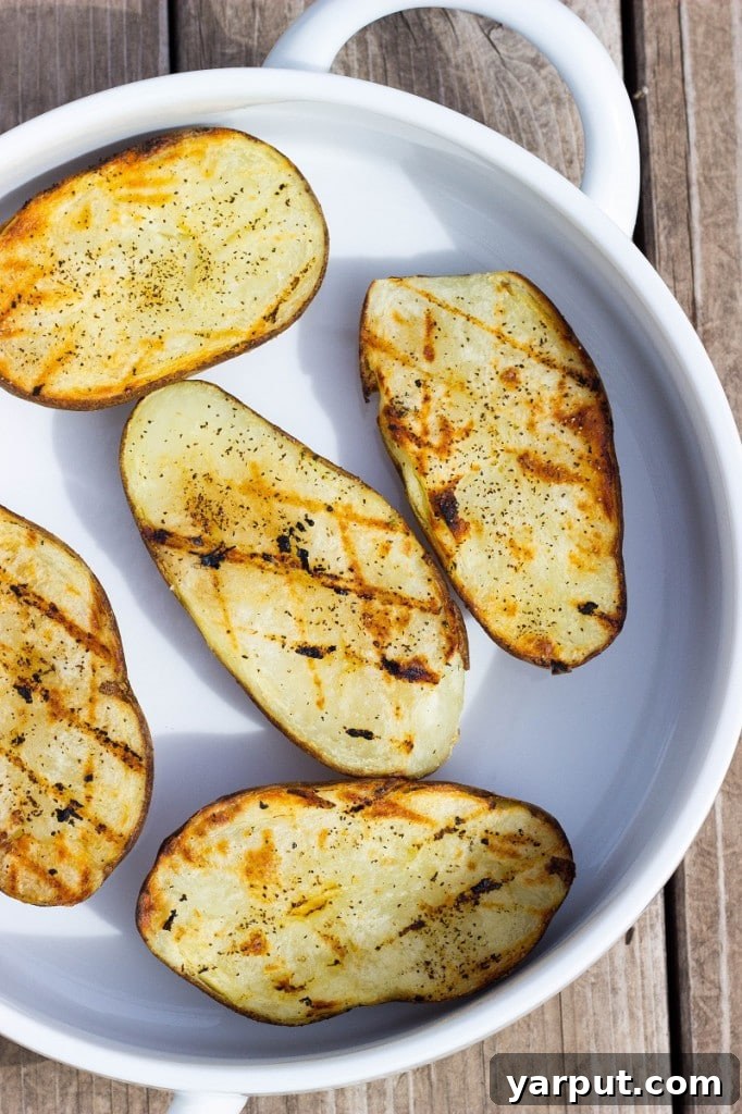 Close-up of golden grilled potatoes with fresh watercress.