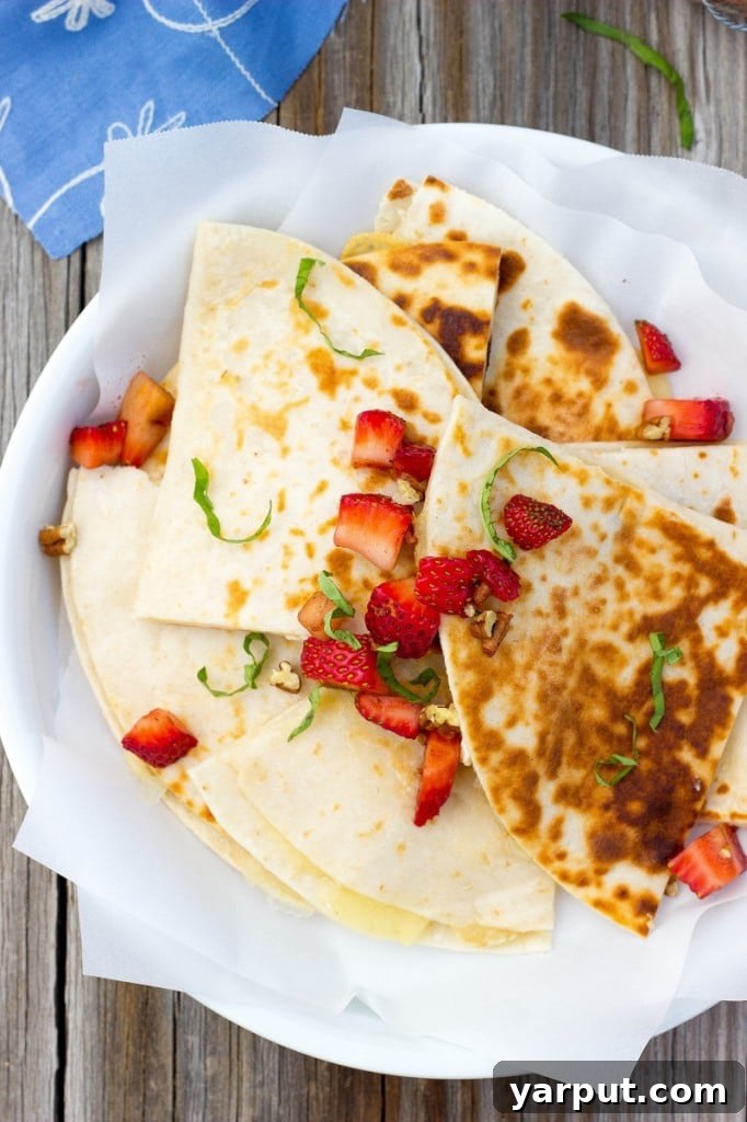 Brie and Strawberry Fusion Quesadillas 4 Golden brown Brie Cheese Quesadilla being assembled