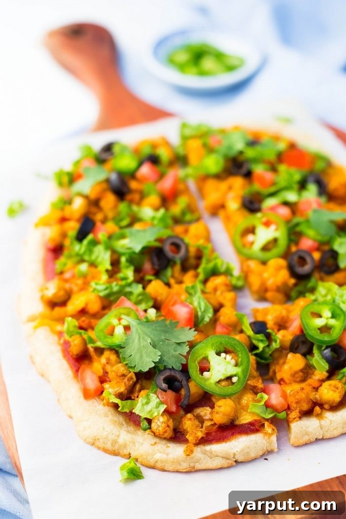 Fiesta Smashed Chickpea Pizza 6 Another enticing view of Smashed Chickpea Taco Pizza, emphasizing its fresh ingredients and inviting texture.