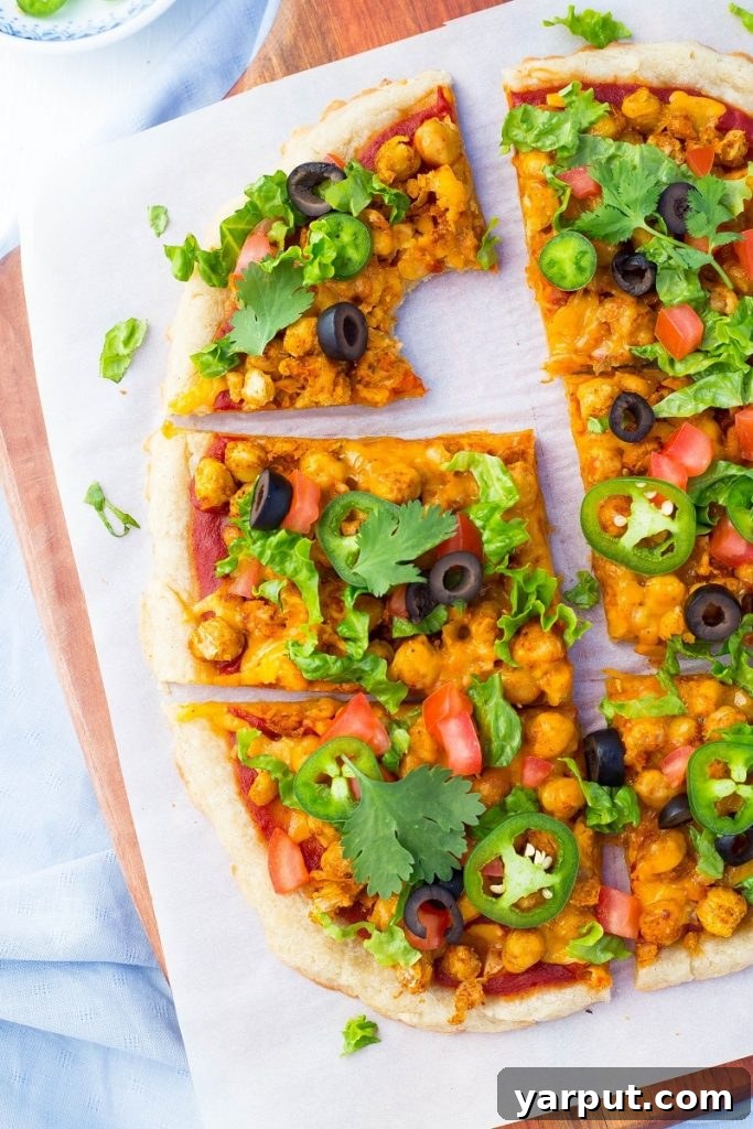 Fiesta Smashed Chickpea Pizza 7 A beautifully presented slice of Smashed Chickpea Taco Pizza, ready to be enjoyed.