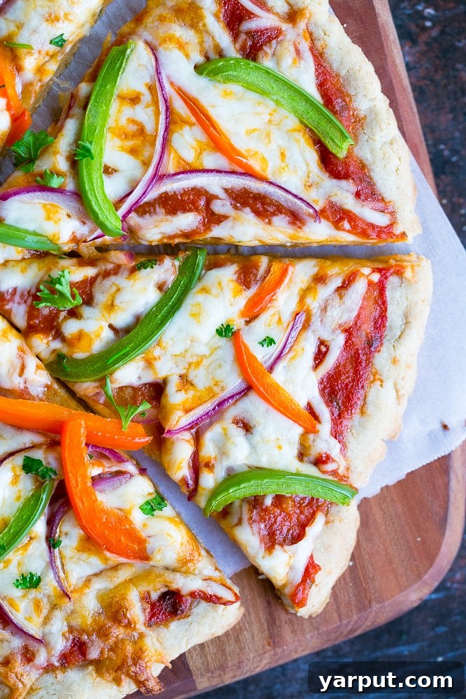 Simple and Delicious Gluten-Free Vegan Pizza Crust 2 Close up photo of a delicious homemade gluten free pizza made with a perfectly cooked gluten free pizza crust, topped with fresh ingredients.