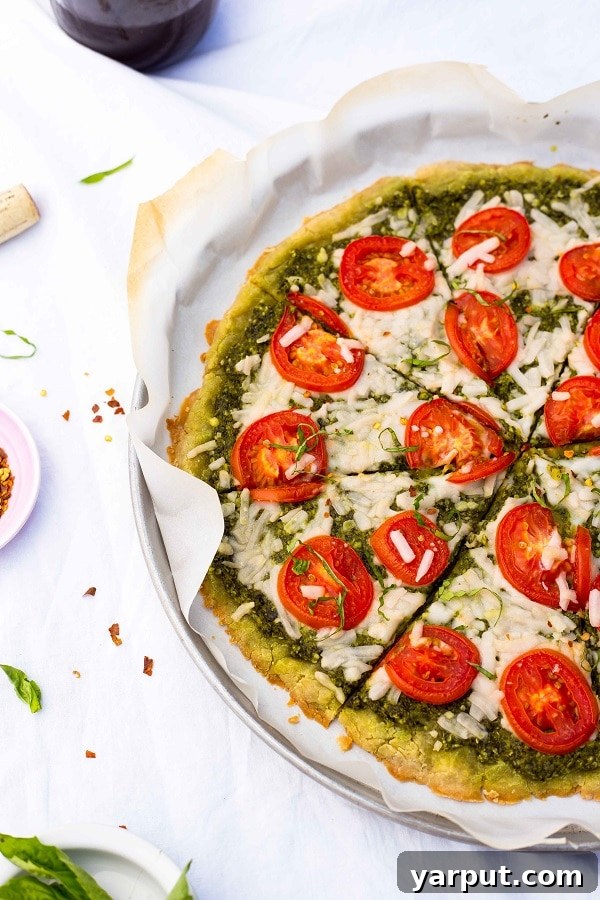 Sun-Kissed Roma Tomato Pesto Pizza Gluten-Free Vegan 6 Hand Reaching for a Slice of Vegan Gluten-Free Pesto Pizza