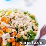 Close-up of a serving of the vibrant Kale Salad with Roasted Sweet Potato, Chickpeas & Avocado