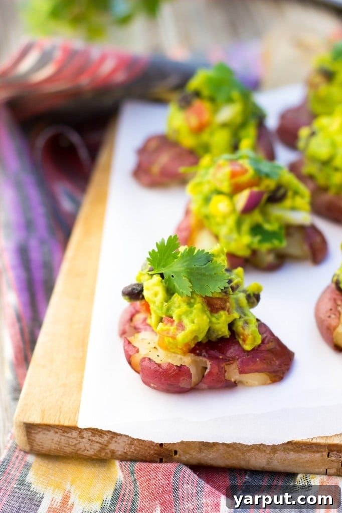 Savor Summer: 13 Vegetarian Avocado Delights 9 Crispy Smashed Potatoes generously topped with a vibrant loaded guacamole