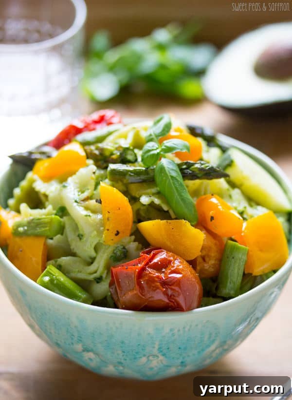 Savor Summer: 13 Vegetarian Avocado Delights 5 Creamy Avocado Pesto Pasta Salad with vibrant roasted summer vegetables