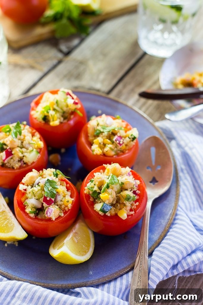 Wholesome Quinoa and Chickpea Stuffed Tomatoes 2 Refreshing Quinoa and Chickpea Stuffed Tomatoes served beautifully