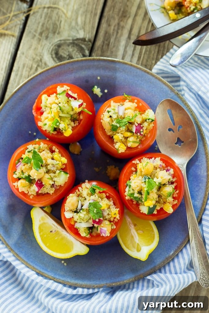 Wholesome Quinoa and Chickpea Stuffed Tomatoes 8 Multiple Quinoa and Chickpea Stuffed Tomatoes on a board