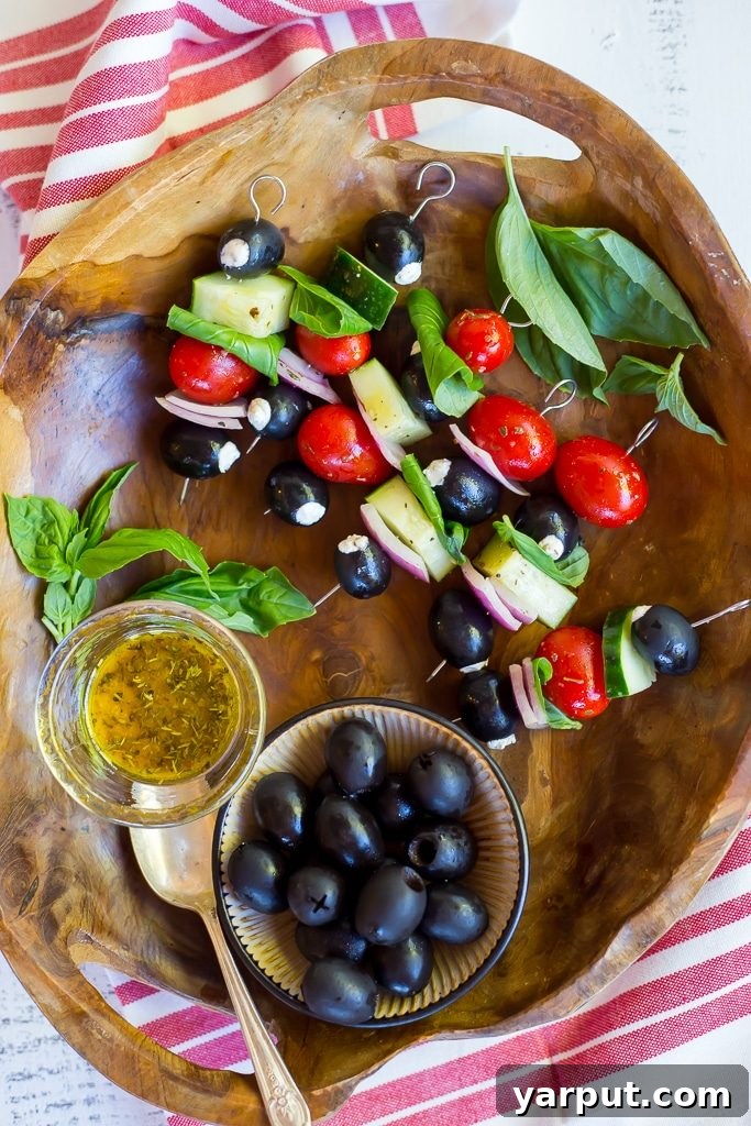 Sun-Kissed Chèvre Stuffed Olive Skewers 7 Goat Cheese Stuffed Black Olive Mediterranean Kabobs arranged artfully on a serving dish