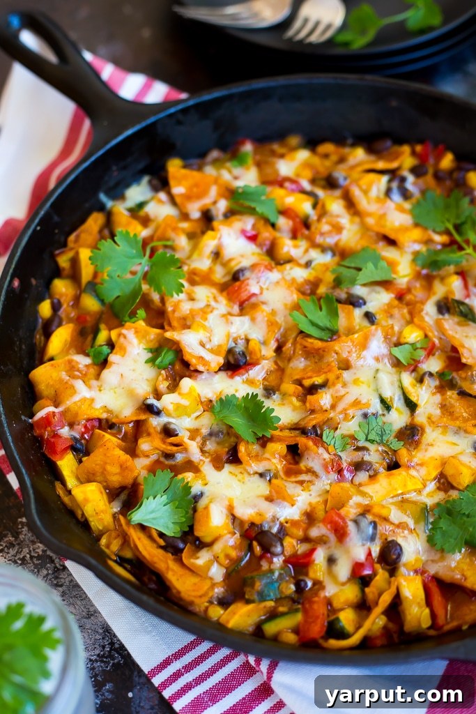 No-Bake Skillet Enchiladas 6 A close up image of delicious stovetop enchiladas, showing the rich texture and melted cheese.