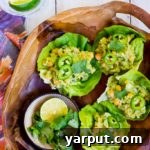 Close-up of a Chickpea Avocado Lettuce Wrap, showcasing the vibrant green lettuce and creamy filling.