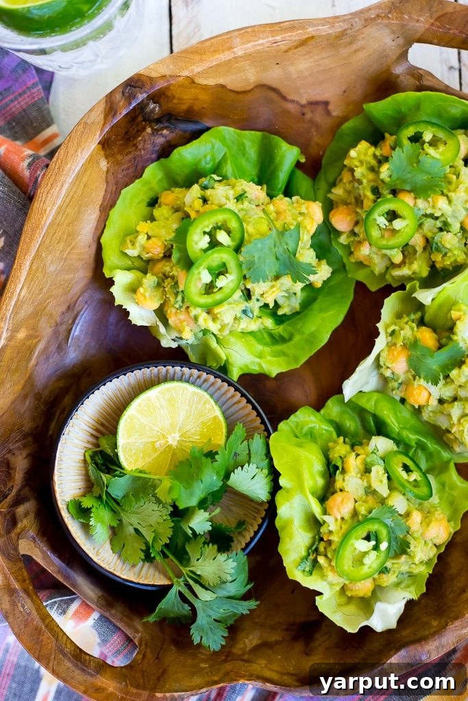 Creamy Chickpea Avocado Lettuce Bites 5 A beautifully presented Chickpea Avocado Lettuce Wrap with a side of fresh lime.
