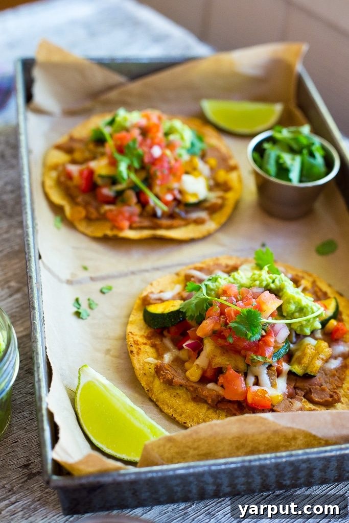 Overhead view of multiple fresh Summer Vegetable Tostadas, ready to serve.