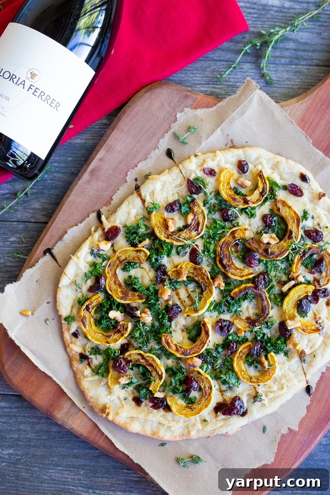Roasted Delicata, Kale & Parmesan Flatbread 5 Deliciously baked Delicata Squash, Kale, and Parmesan Flatbread slices ready to serve at a holiday gathering