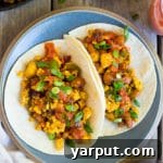 Close-up of a delicious Southwest Tofu Scramble Breakfast Taco with fresh toppings.