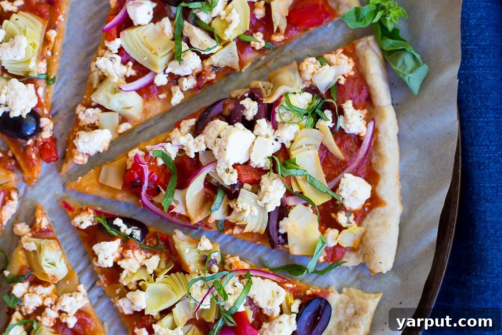 Plant-Based Greek Pizza Gluten-Free 3 Close-up of a delicious Vegan Greek Pizza slice with fresh toppings and homemade tofu feta