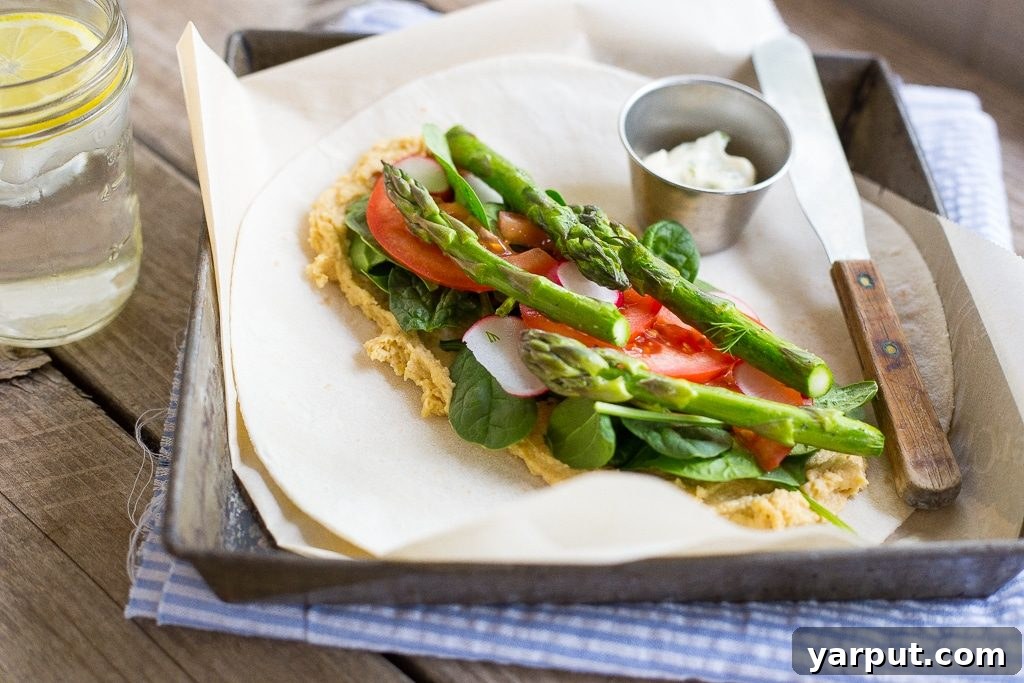 Close-up of a Hummus Wrap with vibrant spring vegetables, showcasing its freshness and appeal for a healthy meal.