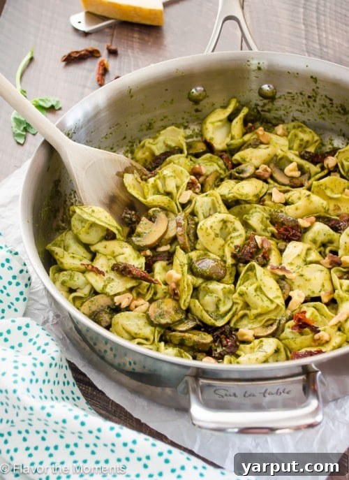 Meatless Muscle 35 Protein Rich Pasta Creations 7 A skillet of 30 Minute Creamy Pesto Tortellini, showing delicious pasta in a rich green sauce, ideal for a quick and satisfying dinner.