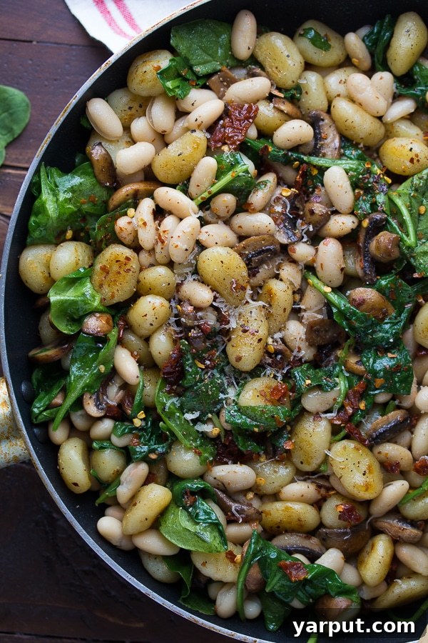 Meatless Muscle 35 Protein Rich Pasta Creations 8 A rustic bowl of Pan Fried Gnocchi with Sun-Dried Tomatoes and White Beans, a hearty and flavorful vegetarian pasta dish.