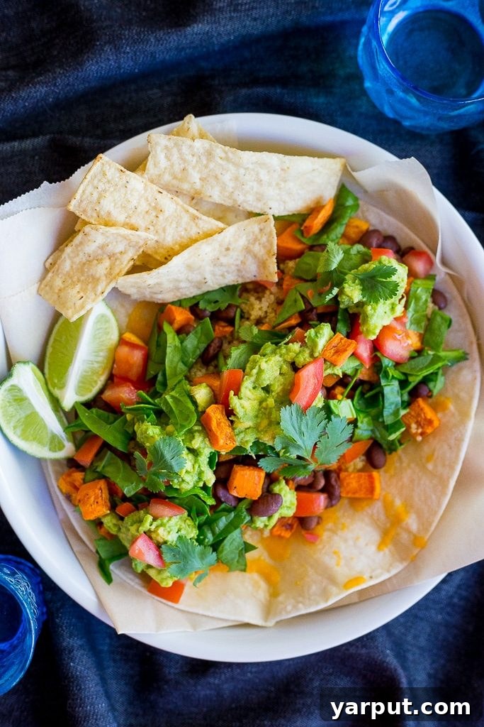 Ultimate Seven Layer Vegetarian Burritos 6 A vibrant and colorful vegetarian 7-layer burrito, freshly made and ready to enjoy, perfect for a healthy gluten-free meal.