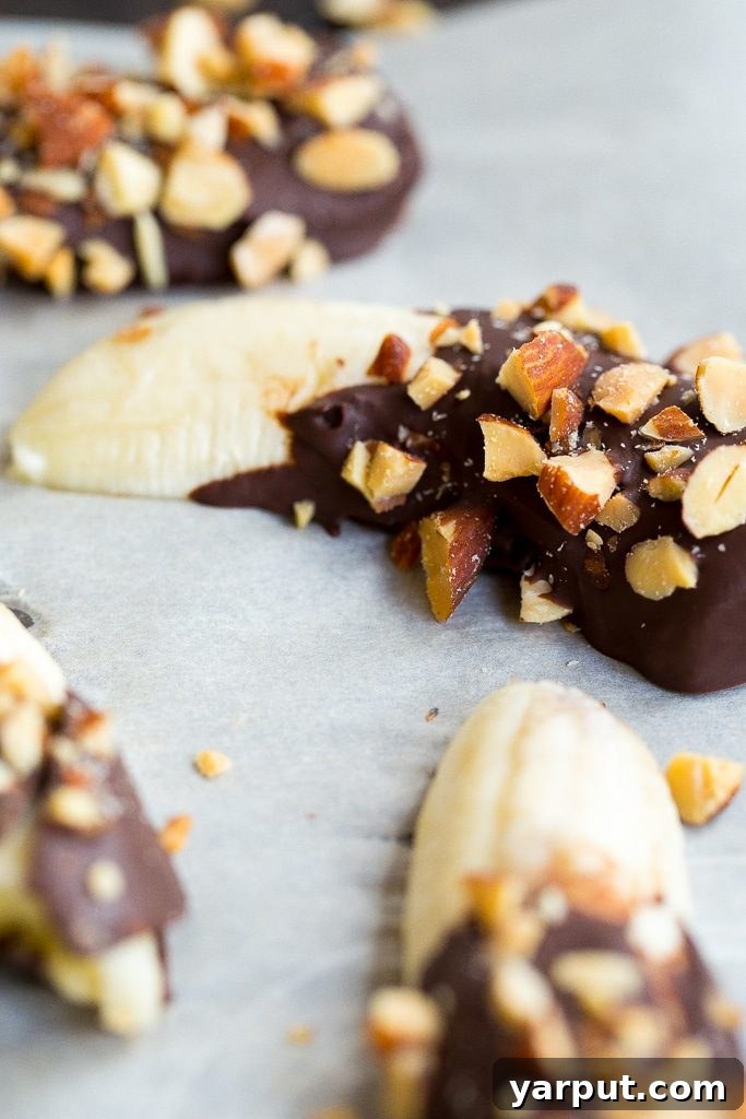 Choco-Almond Frozen Banana Bites 4 Instructions for making Mini Chocolate Covered Frozen Bananas, showing the frozen product with almonds.