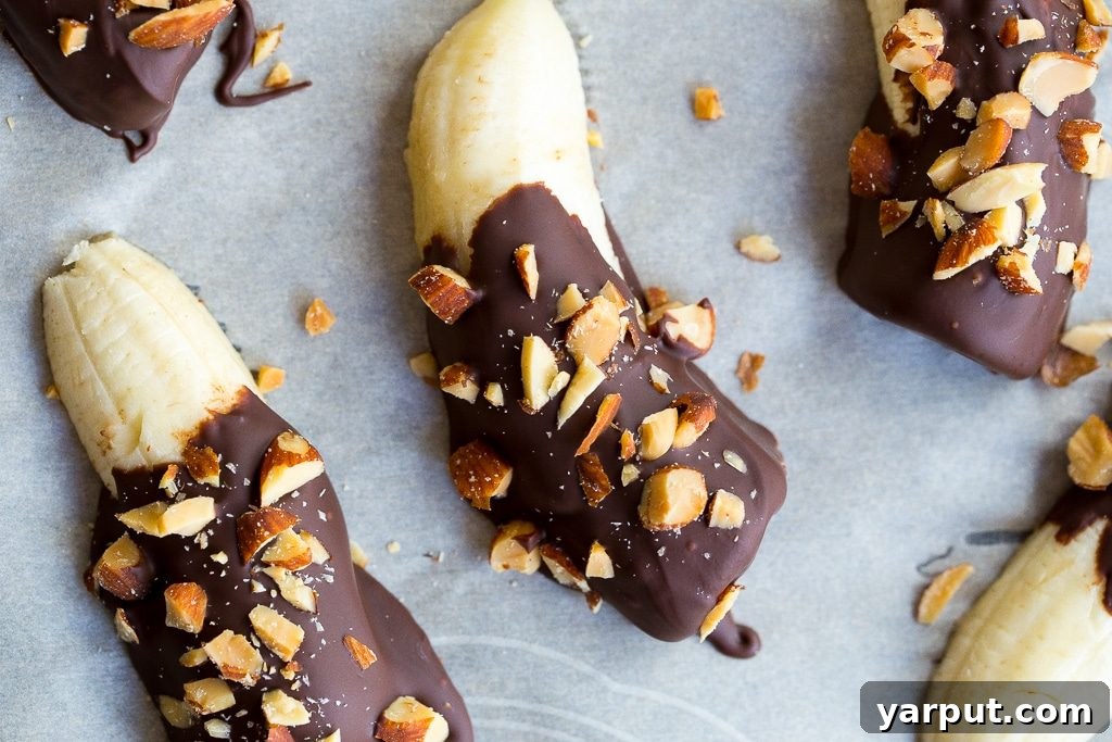 Choco-Almond Frozen Banana Bites 6 Tray of Mini Chocolate Covered Frozen Bananas with Almonds, ready to be served.