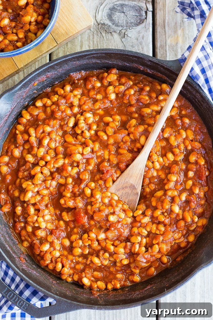 Stovetop Simmered Vegan Beans 2 Cast iron skillet full of stovetop baked beans, ready to serve