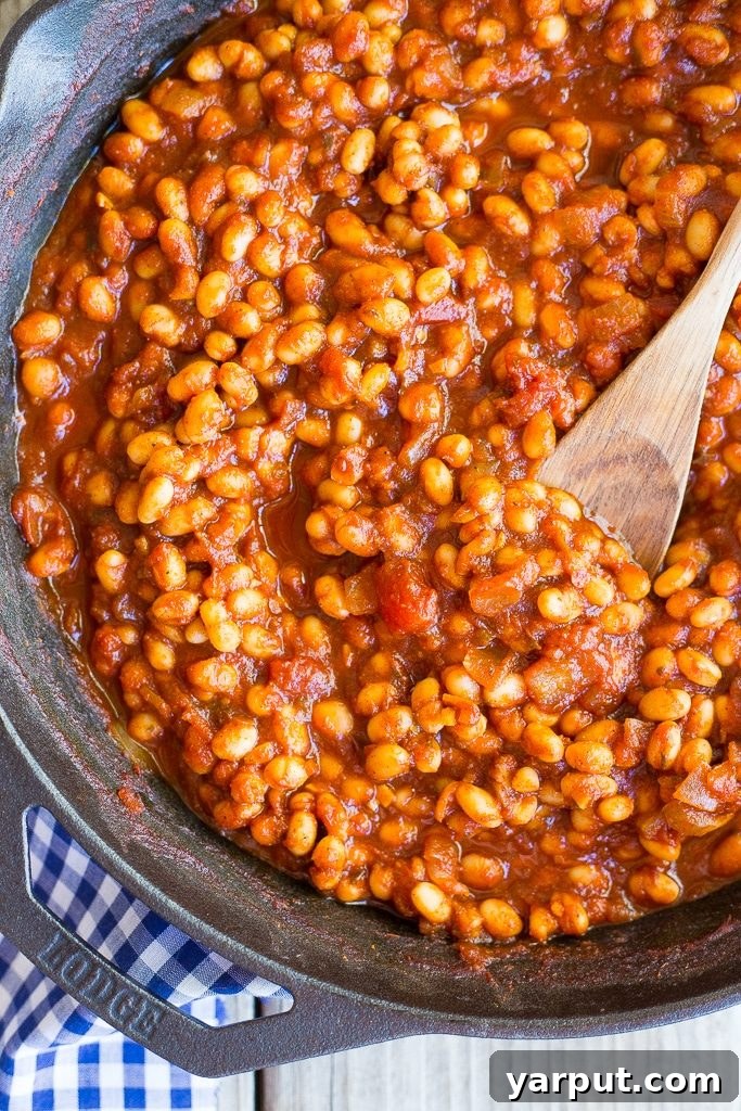 Stovetop Simmered Vegan Beans 5 Stovetop baked beans served in a pan with a serving spoon