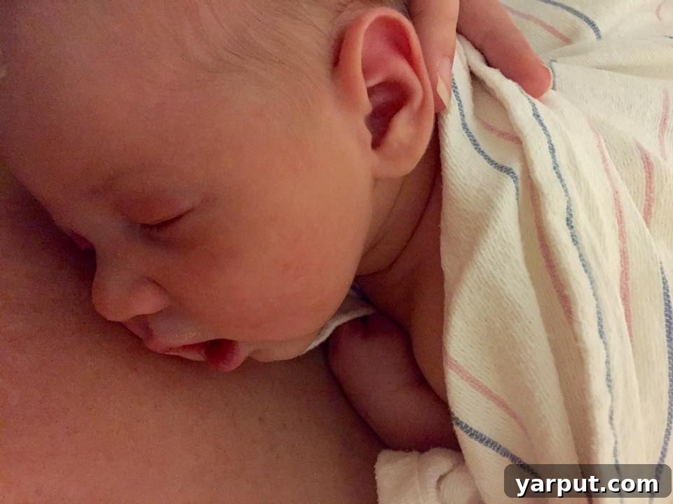 A newborn baby, Elijah, in the NICU, with monitoring equipment.
