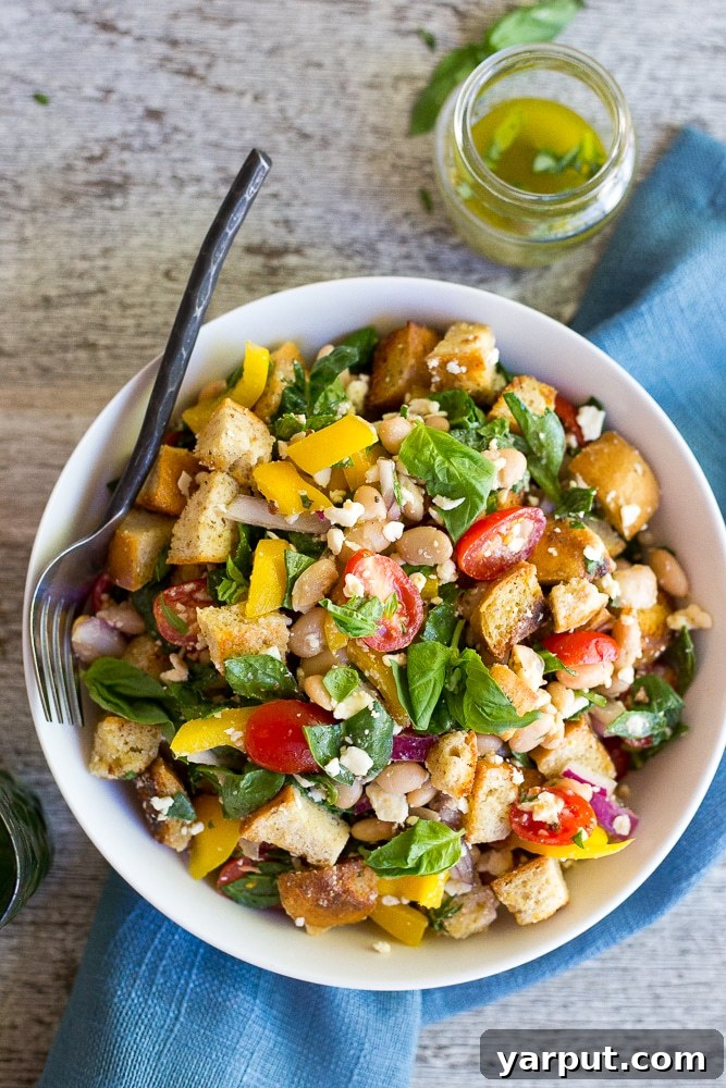 Basil Burst Panzanella with Spinach and White Beans 7 A serving suggestion for the Spinach and White Bean Panzanella Salad, beautifully presented in a rustic bowl, emphasizing its fresh ingredients and appealing colors.