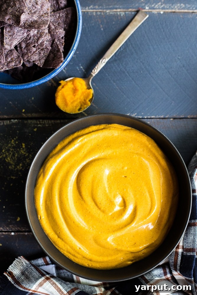 Creamy Vegan Pumpkin Cheeze Sauce 2 Creamy Vegan Pumpkin Cheese Sauce served with tortilla chips, perfect for dipping and plant-based meals.