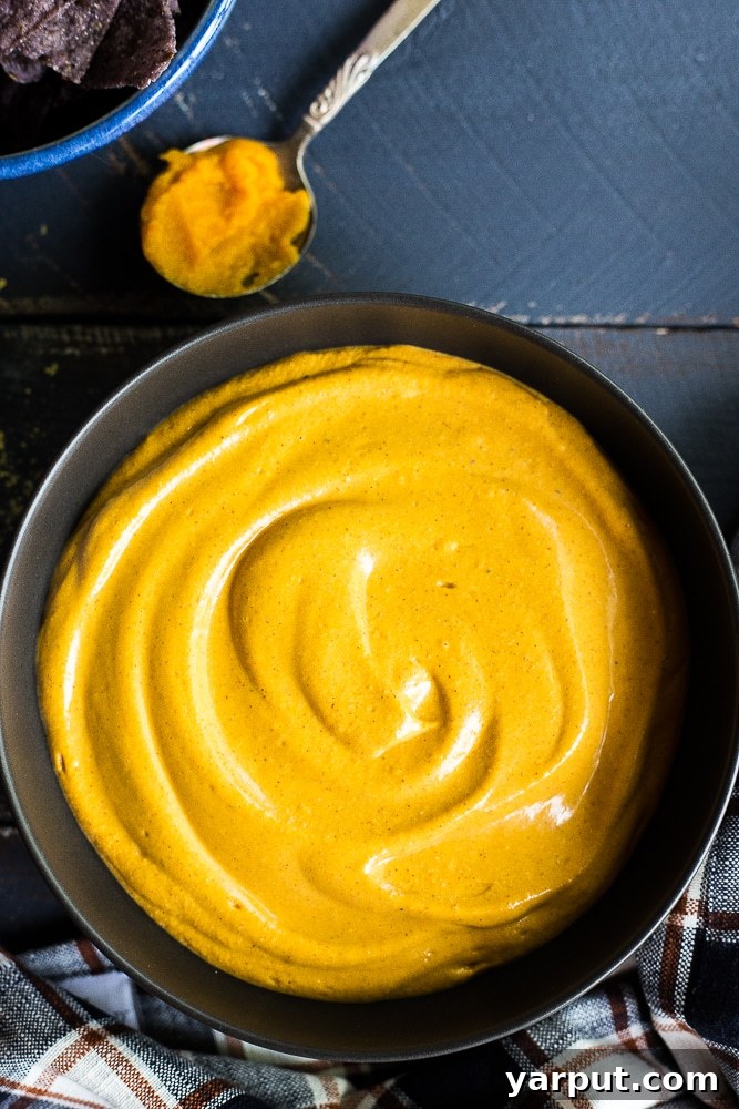 Creamy Vegan Pumpkin Cheeze Sauce 4 A close-up of the smooth, rich vegan pumpkin cheese sauce in a white bowl, ready to be served.