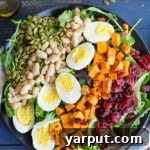 A vibrant Vegetarian Cobb Salad with Roasted Sweet Potato, garnished and ready to serve.