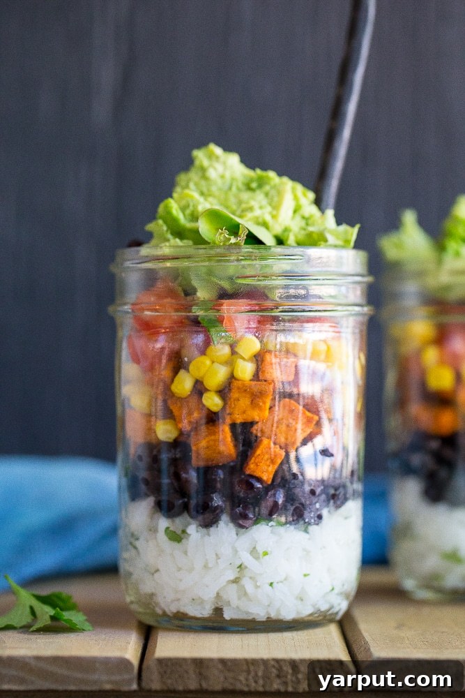 Portable Plant-Based Burrito Bowls 4 Four assembled Vegetarian Mason Jar Burrito Bowls in a row, with the lids on, showcasing their vibrant layers and readiness for convenient meal prep. Perfect for healthy lunches throughout the week.