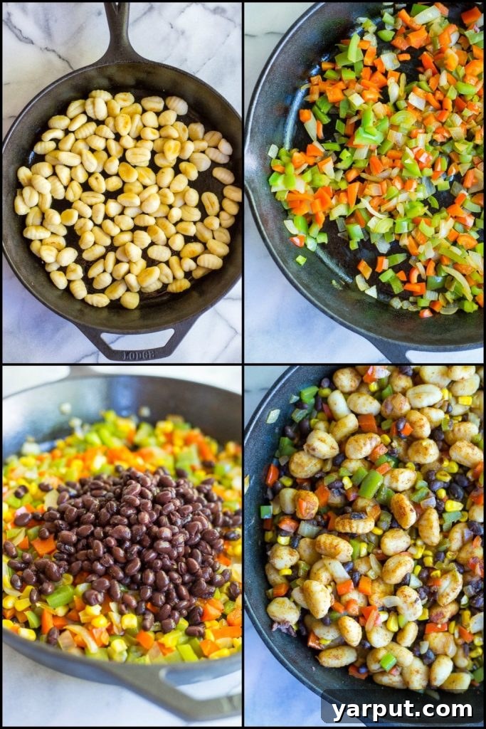 Close-up of the Gnocchi Enchilada Skillet, showcasing browned gnocchi, colorful peppers, and black beans coated in a savory enchilada sauce.