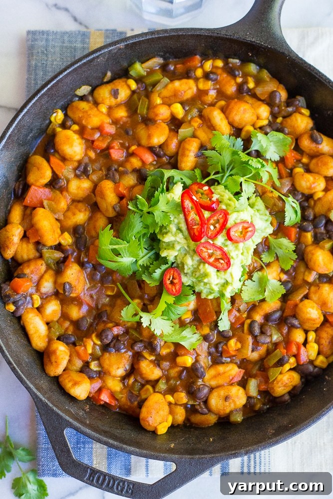 A serving of the Gnocchi Enchilada Skillet garnished with fresh cilantro, ready to be enjoyed as a quick and healthy meal.