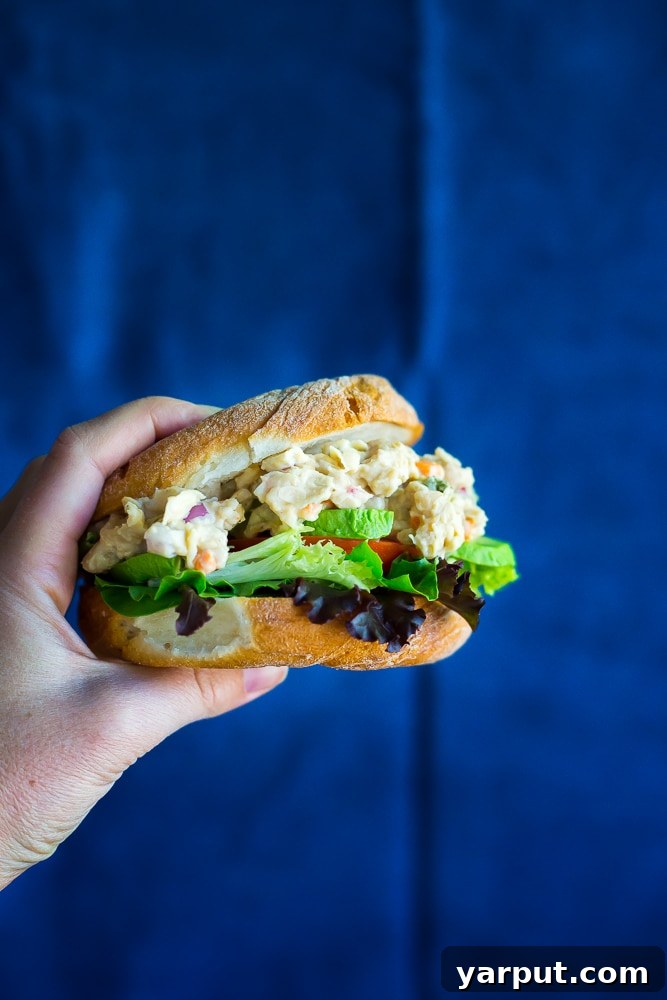 Quick & Hearty Chickpea and White Bean Sandwich Filling 5 Finished chickpea and white bean salad sandwiches presented on a plate, ready to eat.