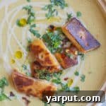 A small image of the Easy Falafel Soup, topped with tahini and fresh herbs.
