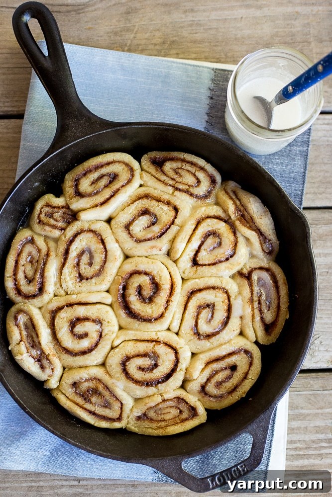 Decadent Vegan Gluten-Free Cinnamon Rolls 2 A large pan filled with the best gluten-free cinnamon rolls, beautifully golden and topped with glaze.