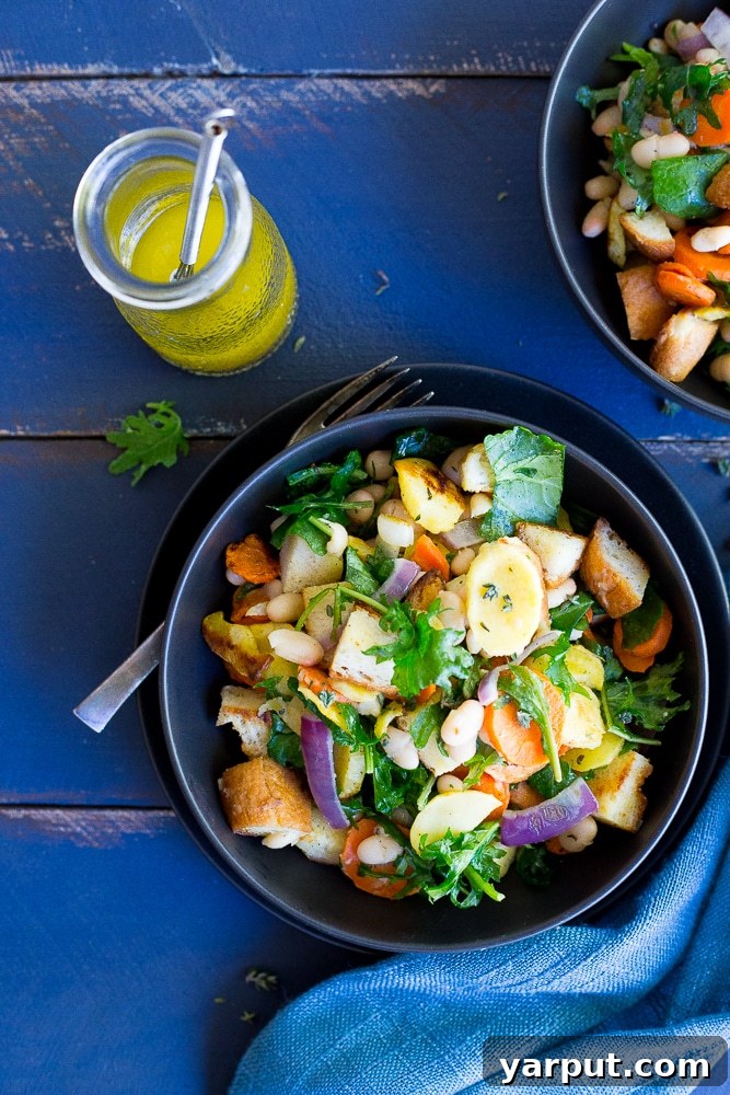 Hearty Panzanella with Roasted Winter Roots 4 A serving of Winter Panzanella Salad, showcasing roasted vegetables, crispy bread, and fresh kale
