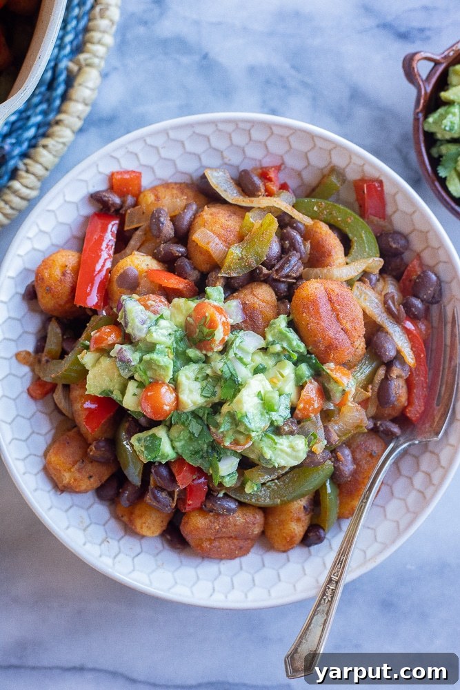 Fiesta Gnocchi Skillet with Fresh Avocado Salsa 6 A beautifully presented dinner bowl filled with Fajita Gnocchi Skillet and a generous serving of avocado salsa.