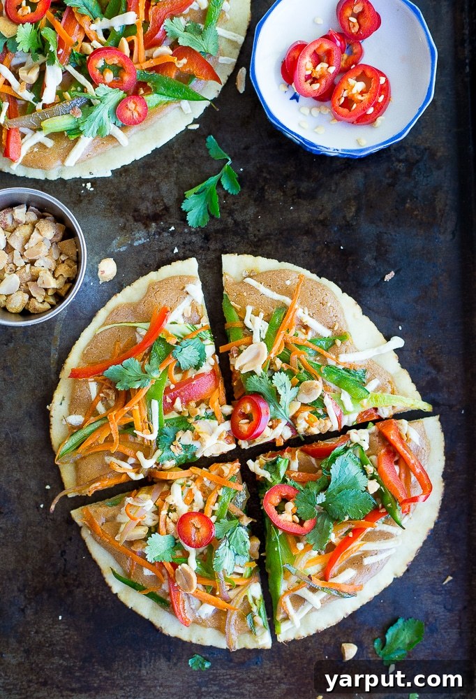 Effortless Thai Veggie Pita Pizzas 8 Close-up of freshly baked Thai Vegetable Pita Pizzas, showcasing their vibrant colors and melted cheese.