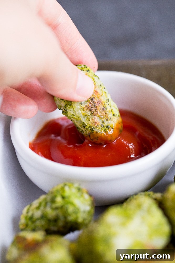 Healthy 4-Ingredient Broccoli Tots 4 Broccoli tater tots cooling on a wire rack after being baked, showing a golden brown crust
