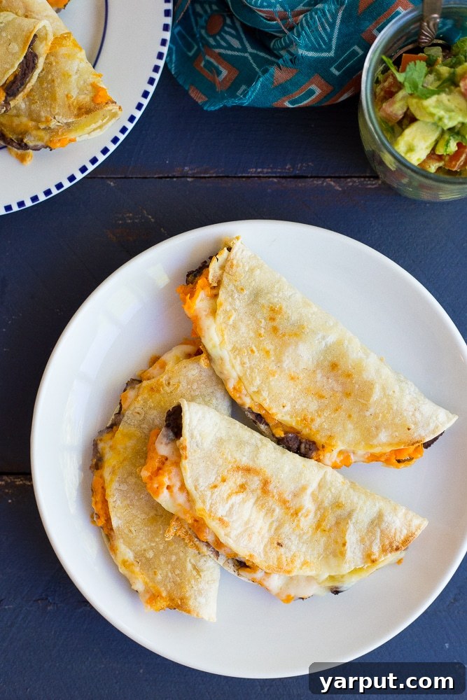 Golden Baked Sweet Potato and Black Bean Tacos 3 Crispy Baked Black Bean & Sweet Potato Tacos - A vibrant and easy vegetarian dinner idea, packed with flavor and ready in half an hour!